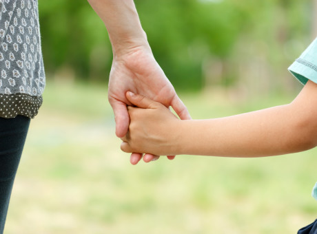 Mother holding a hand of her son